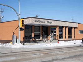 The facade of a brick building, with the letters "Centennial Library" at the top of the building.